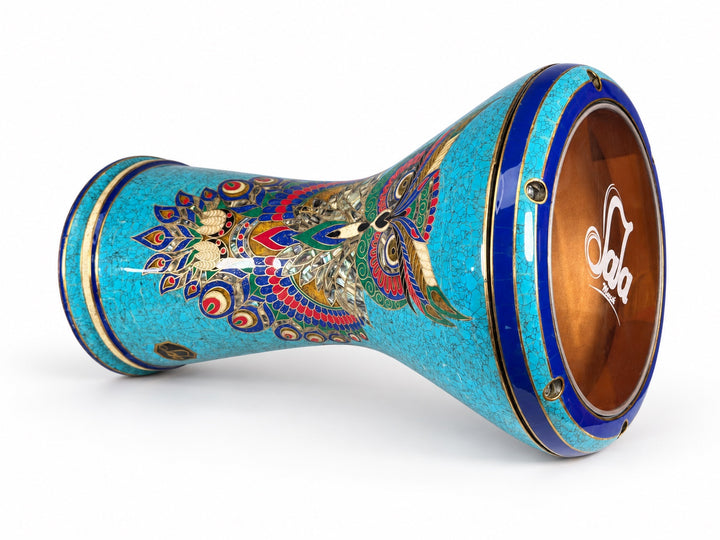 Sala Azure Owl Sombaty darbuka on its side, showing the Sala-branded drumhead and a colorful owl motif on turquoise mosaic with deep-blue borders.